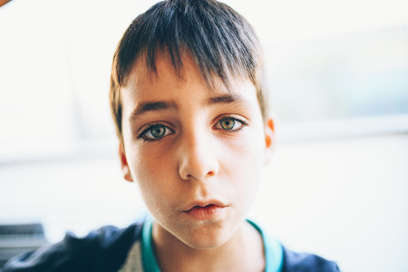 Boy with green eyes looking at cameraの写真素材