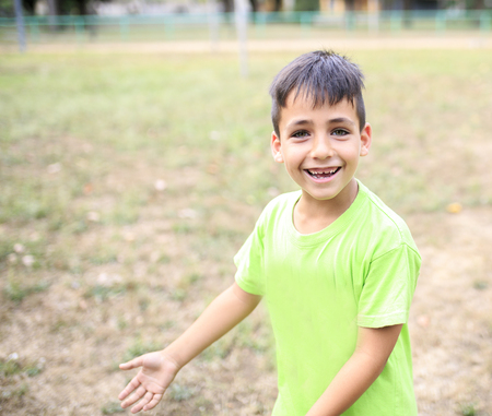 Green eyes boy  smiling the parkの写真素材