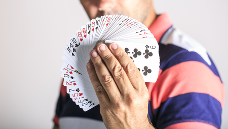 Man showing playing card in his hand