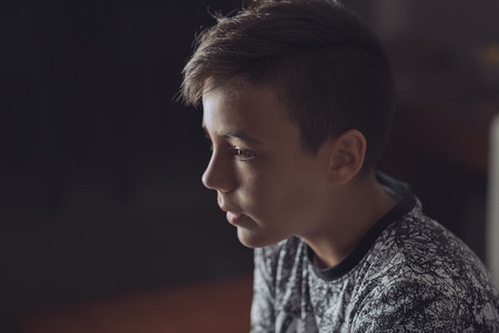 Boy with green eyes looking at the television