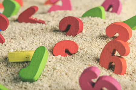 Colored number buried in the sand dunesの写真素材