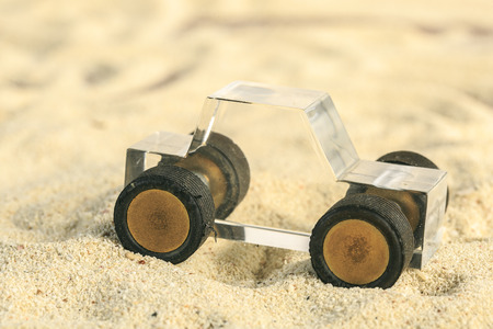 Transparent Methacrylate toy car in the sandの写真素材