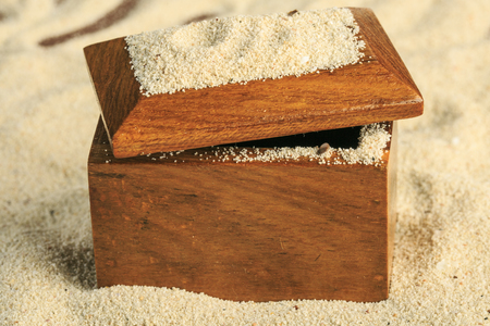 Wooden chest opened on the sand beachの写真素材