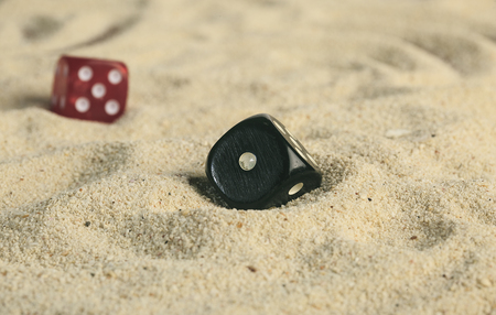 some dices in the sand dunesの写真素材