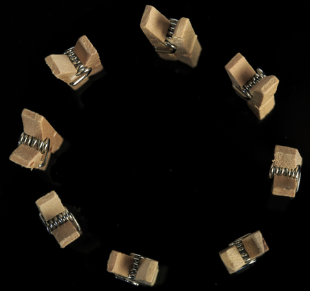 Group of wooden clothes pin in black backgroundの写真素材