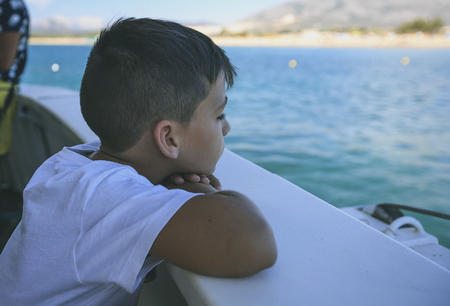 Boy in a deck of a cruiseの写真素材