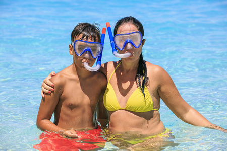 Mother and son snorkeling on the beachの写真素材