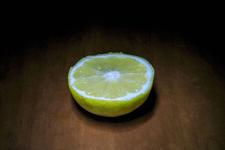 isolated slice of lemon in the shadowの写真素材