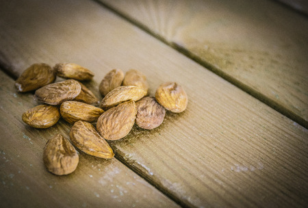 Group of almonds on a wooden tableの写真素材