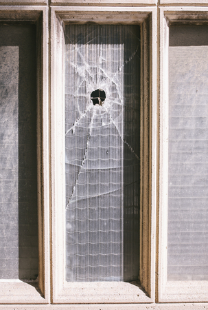 old window with a holeの写真素材