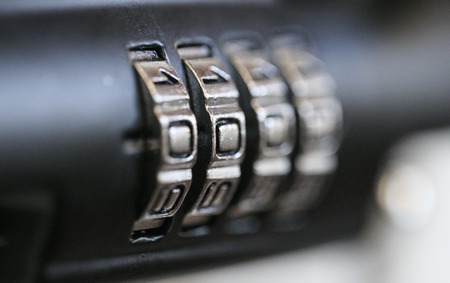 combination padlock in a wooden doorの写真素材