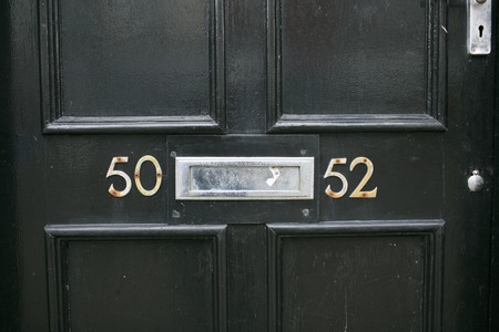 Address number in a wooden doorの写真素材