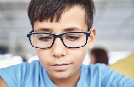 Green eyes boy with glasses