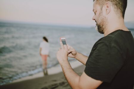 Man on the beach making a call