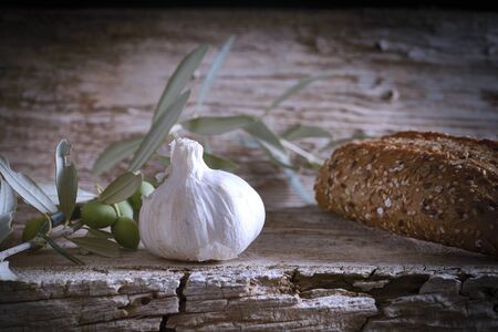 Mediterranean diet. Bread with vegetables composition in a wooden tableの写真素材