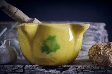 Yellow mortar to make a sauce called allioli, typical of Catalonia. Spain.の写真素材