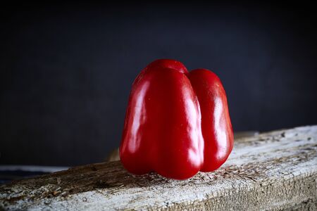 Red sweet pepper in a wooden table . Healthy foodの写真素材