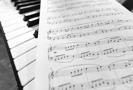 Classic piano and musical sheet . Black and white photo, Musical Backgroundの写真素材