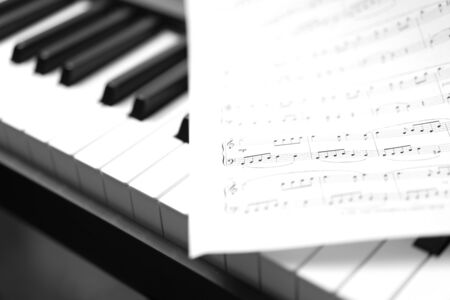 Classic piano and musical sheet . Black and white photo, Musical Backgroundの写真素材