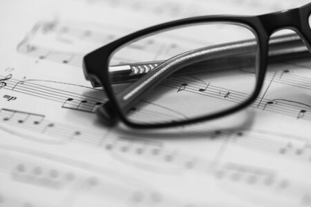 Closeup of Sheet Music and eyeglasses. Musical Notes with Selective Focus.の写真素材
