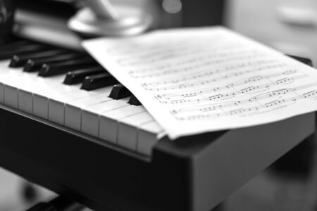 Electronic piano and musical sheet . Black and white photo, Musical Backgroundの写真素材