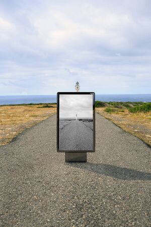 Poster billboard on the road to a lighthouse .Blank advertising billboard mockup in the streetの写真素材