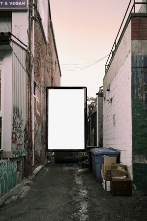 Poster billboard on city dirty alley background .Blank advertising billboard mockup in the streetの写真素材