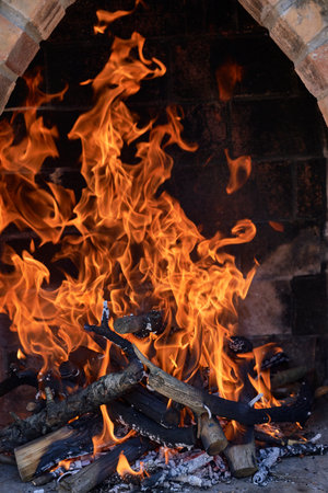Empty flaming charcoal grill with open fire, ready for product placement.の写真素材