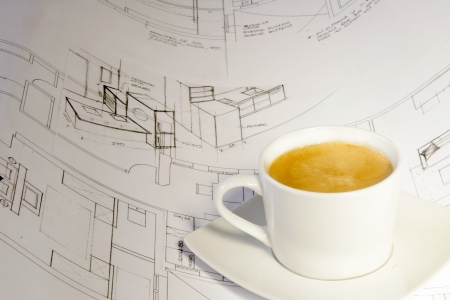 Rolls of architecture blueprint, house plane drinking a coffeeの写真素材