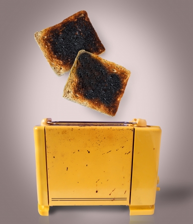 Burnt toast popping out of a chaotic toasterの写真素材