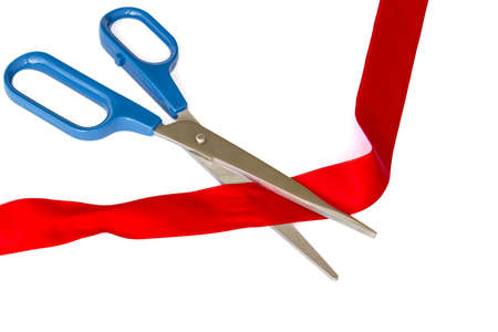 Closeup image of scissors cutting a red ribbonの写真素材