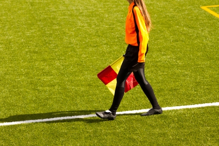 Female soccer referee hold the flag during a matchの写真素材