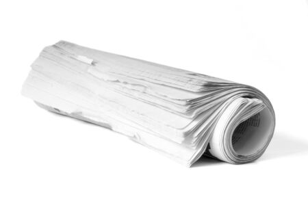 Roll of newspaper on a white backgroundの写真素材