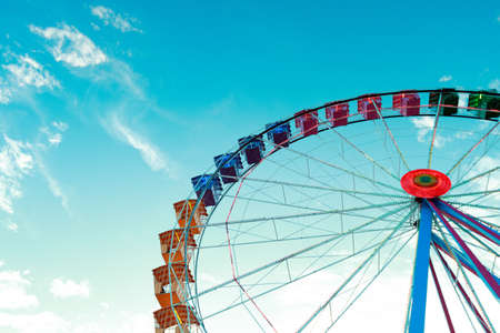 Ferris wheel against turquoise skyの写真素材