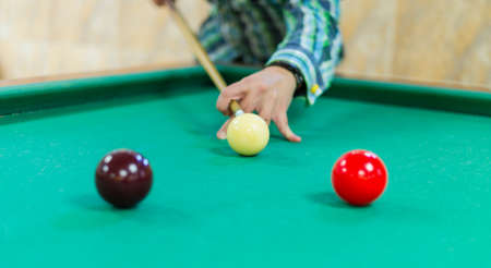 Young man playing snooker. Billiardの写真素材