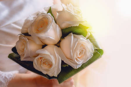 Close up of a wedding bouquet in hands of the brideの写真素材