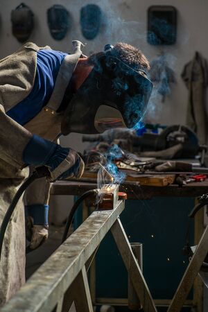 Welder in workshop manufacturing metal constructionの写真素材