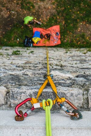 Close-up of a rock climbing rope with hooks on rockの写真素材