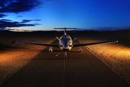 Single turboprop aircraft on the groun, night