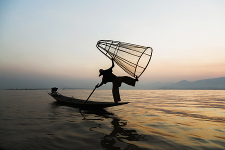 Fishermen in Inle lakes sunset, Myanmar. Fishermen is finish a day of fishing in Inle lake, Myanmar (Burma). Inle is one of the most favorite tourist places in Myanmar (Burma)の写真素材