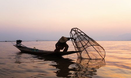 Fishermen in Inle lakes sunset, Myanmar. Fishermen is finish a day of fishing in Inle lake, Myanmar (Burma). Inle is one of the most favorite tourist places in Myanmar (Burma)の写真素材