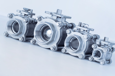 Group 4 valves located on the diagonal, different sizes, ball valve with selective focus on thread fittingsの写真素材