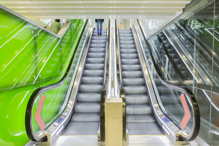 Botton view of escalators, green color combination. panoramic angle of escalator detail.の写真素材