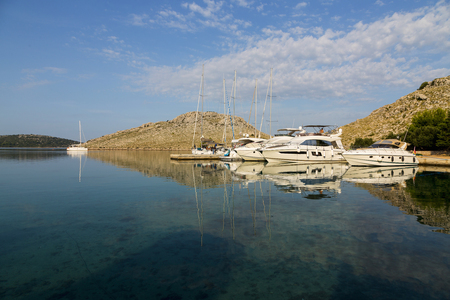 Magnificent azure sea and the bay with the parking luxury yachts in National Park Kornati, Croatiaの写真素材