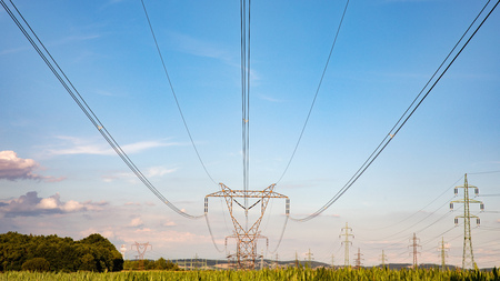 High voltage pylon on skies background, Transmission line tower in countrysideの写真素材