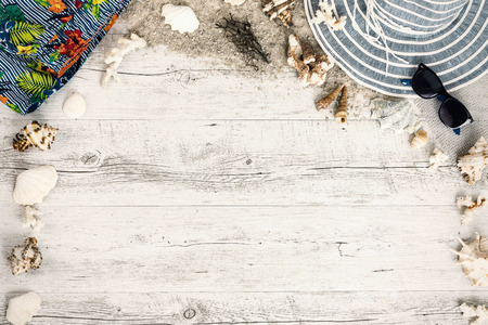 Sand and shells and hat on the wooden floor, summer concept, travel Seychely, beach Florida, Hawai, swimm in Bali, summer pradiseの写真素材
