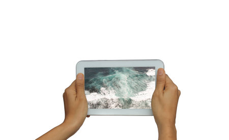 Holding tablet with picture from vacation on sea resort
