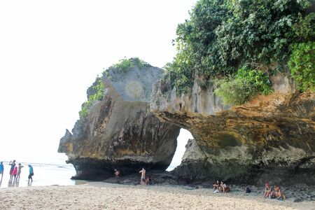 Bali, Indonesia - June 11 2014 : people enjoying beach hidden under big rocksのeditorial素材