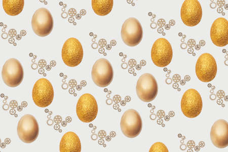 Creative Easter pattern made with golden , glitter egg and gearwheel .Flat lay minimal background.の写真素材