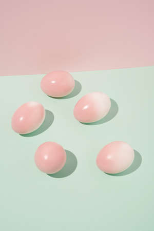 2022 Easter still life real unique composition.  Pink eggs on mint green background.  Creative ...